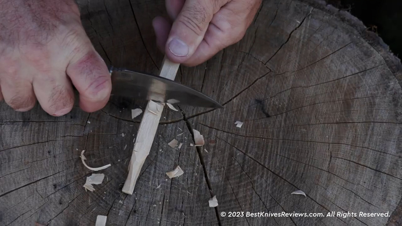 Schrade Radok cutting wood stick